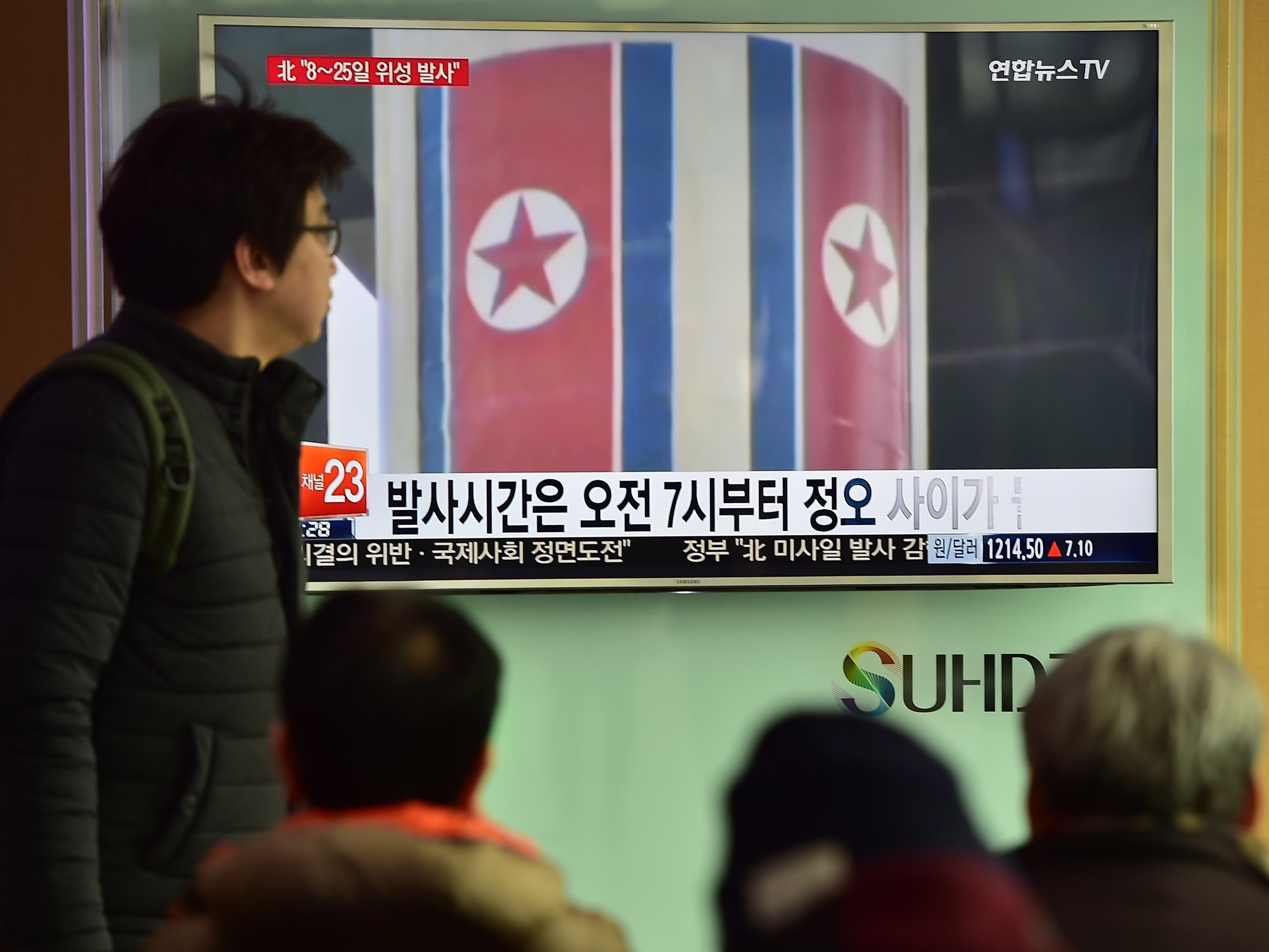 People watch a news report at a railway station in Seoul on Feb. 3. North Korea launched a long-range rocket Sunday local time, defying international criticism. (AFP/Getty Images)