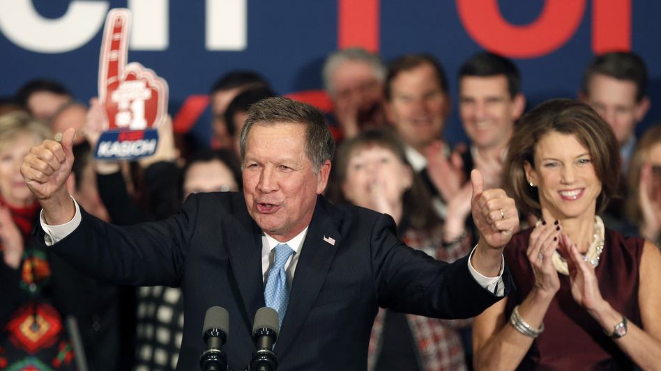 Ohio Gov. John Kasich, with his wife, Karen Waldbillig, at his side, cheers with supporters Tuesday at his Republican primary night rally in Concord, N.H. (Jim Cole/AP)