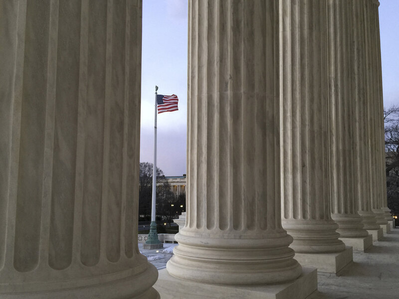 The American flag, seen through the columns of the Supreme Court building, blows in the wind on Feb. 13. The American flag, seen through the columns of the Supreme Court building, blows in the wind on Feb. 13.