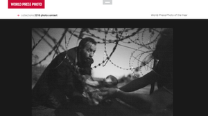 A man passes a baby through the fence at the Serbia/Hungary border in Röszke, Hungary, 28 August 2015.