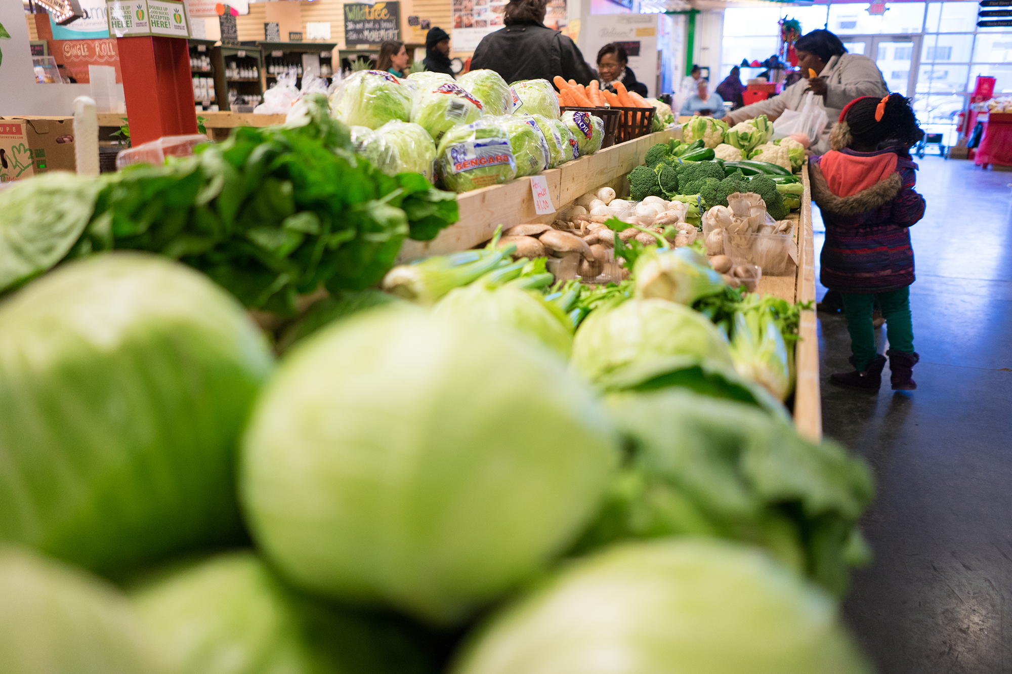 Customers shop for produce at the Flint Farmers' Market this week.