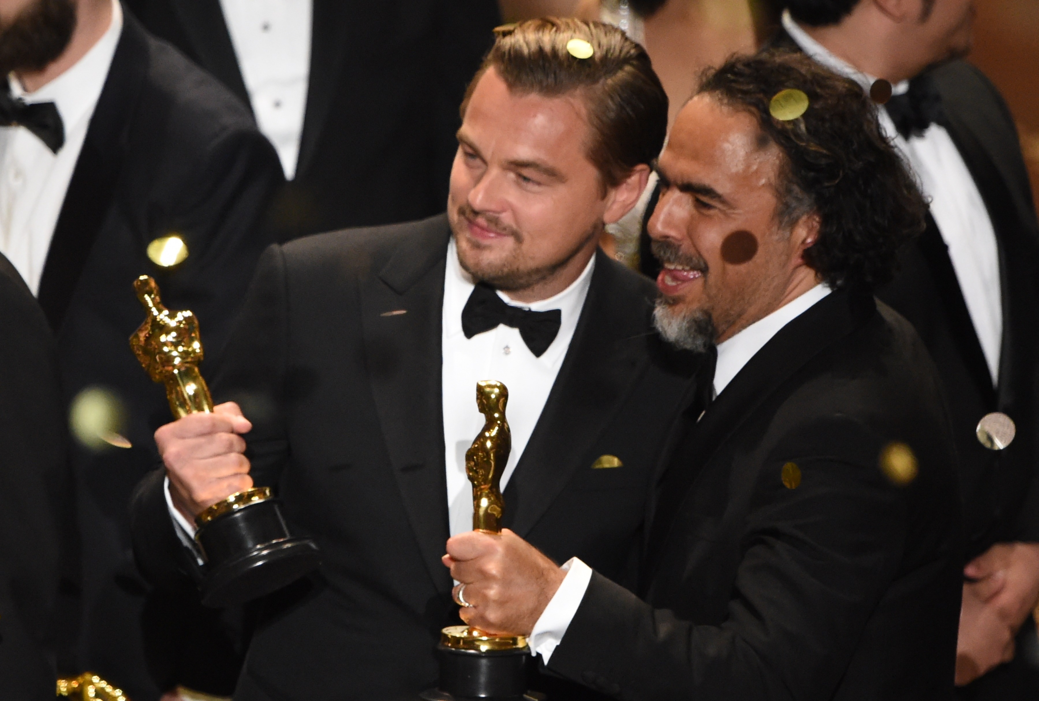 Leonardo DiCaprio and director Alejandro Gonzalez Inarritu celebrate their awards on stage at the 88th Oscars on Sunday. (AFP/Getty Images)