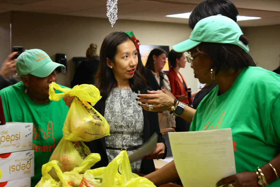 Dr. Leana Wen helps distribute groceries to seniors in a Baltimore neighborhood with few fresh food options. (Courtesy of Lizzy Unger/Baltimore City Health Department)
