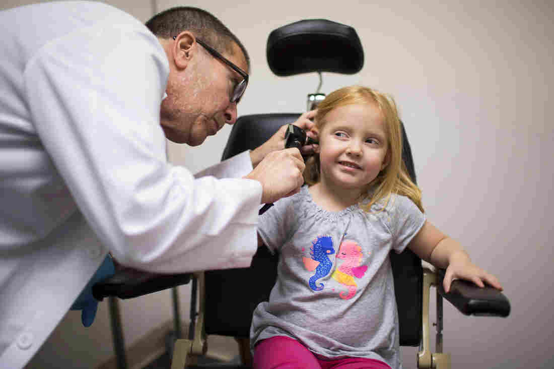 Dr. Max Lebow examines the ear of 4-year-old Charlotte Anderson at Reliant Immediate Care in Los Angeles. Charlotte's mom brought her to the urgent care clinic because Charlotte was having balance problems.