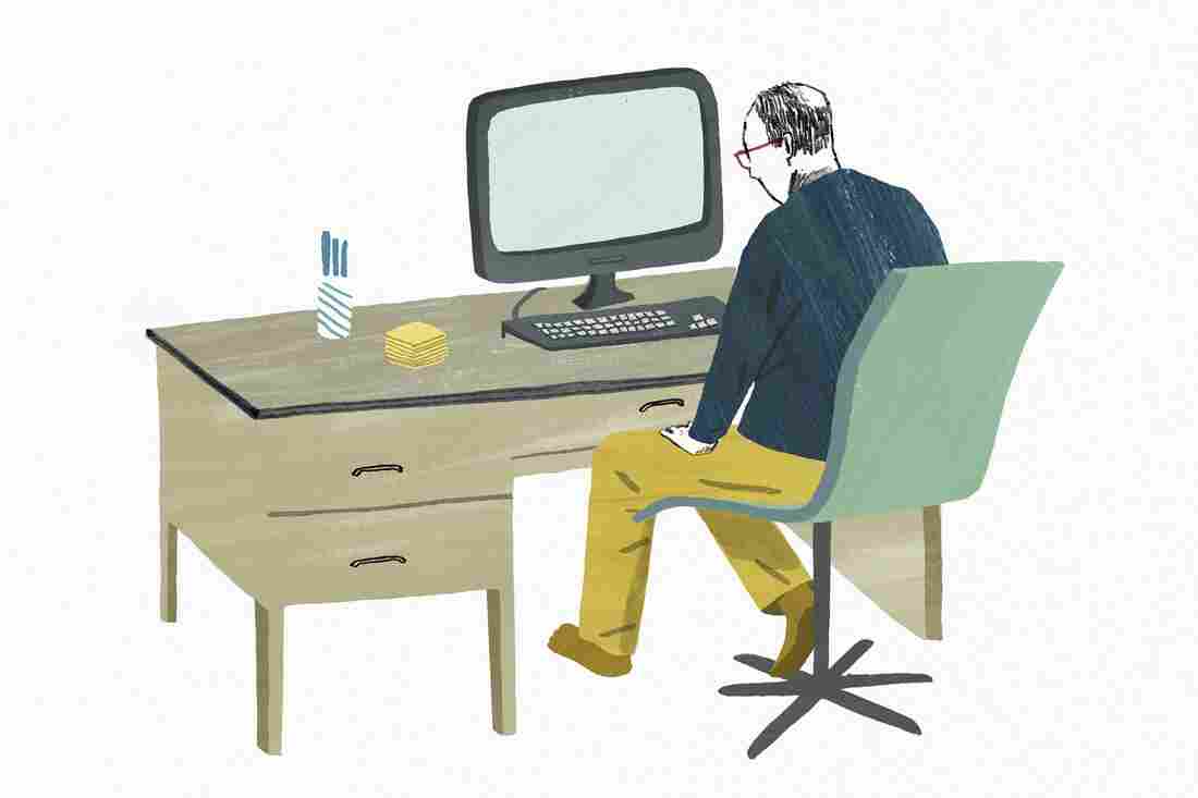 Man sitting at desk staring at blank screen