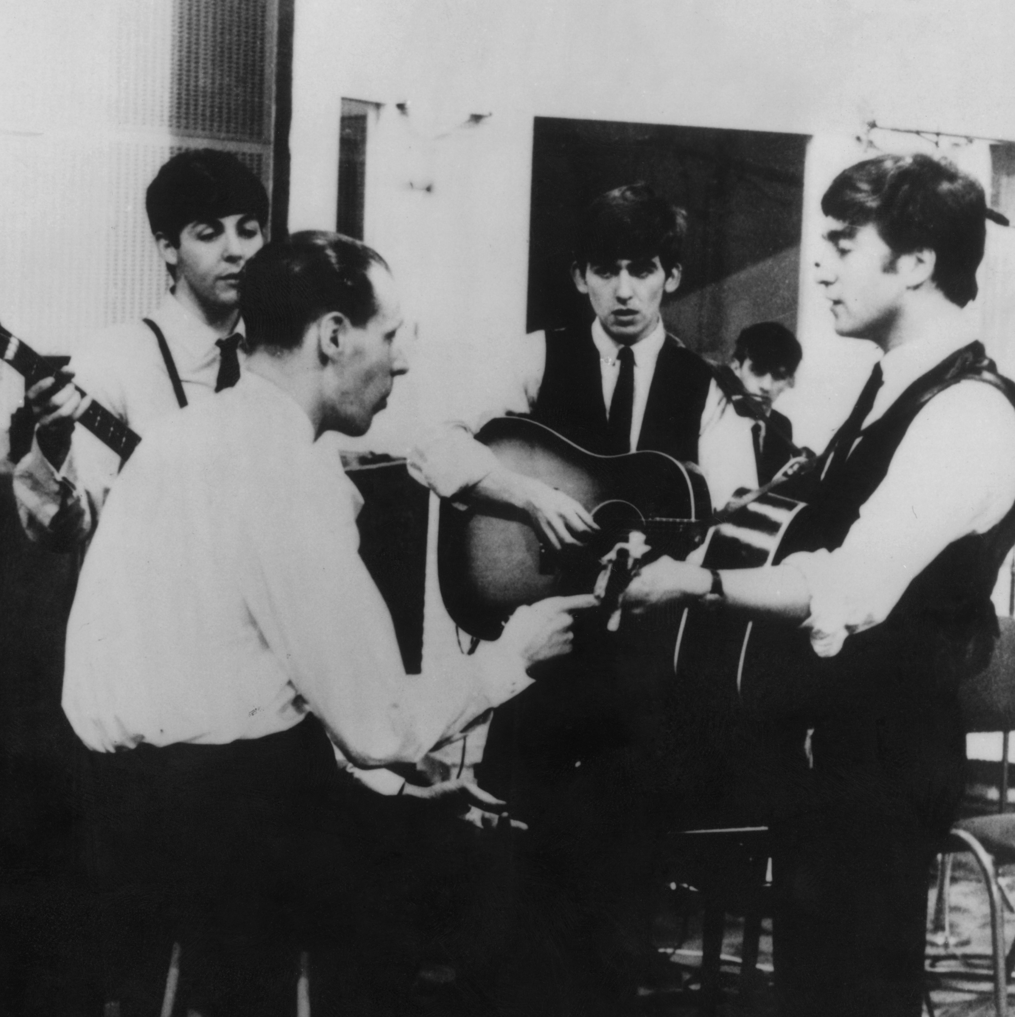 Producer George Martin in a recording session with The Beatles.