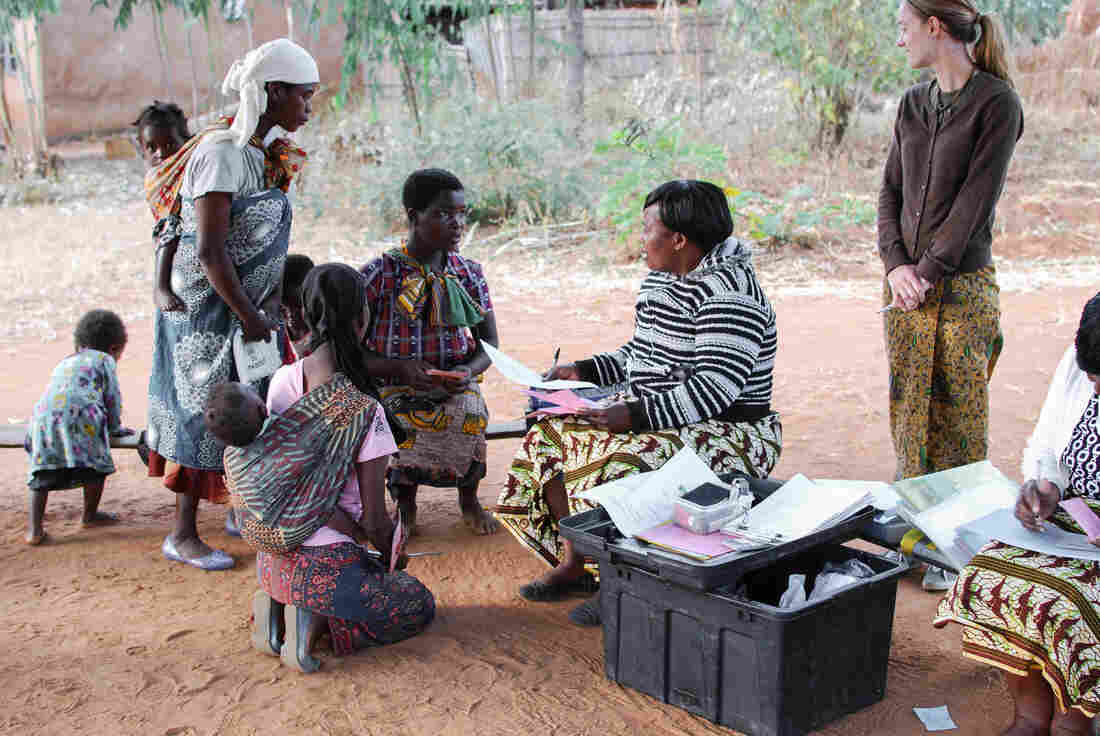 At a program aimed at preventing malnutrition in rural Malawi, nurse Lydia Kamenya counsels a young mother about a proper diet for children.