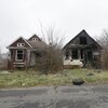 Abandoned homes molder on the east side of Detroit last year.