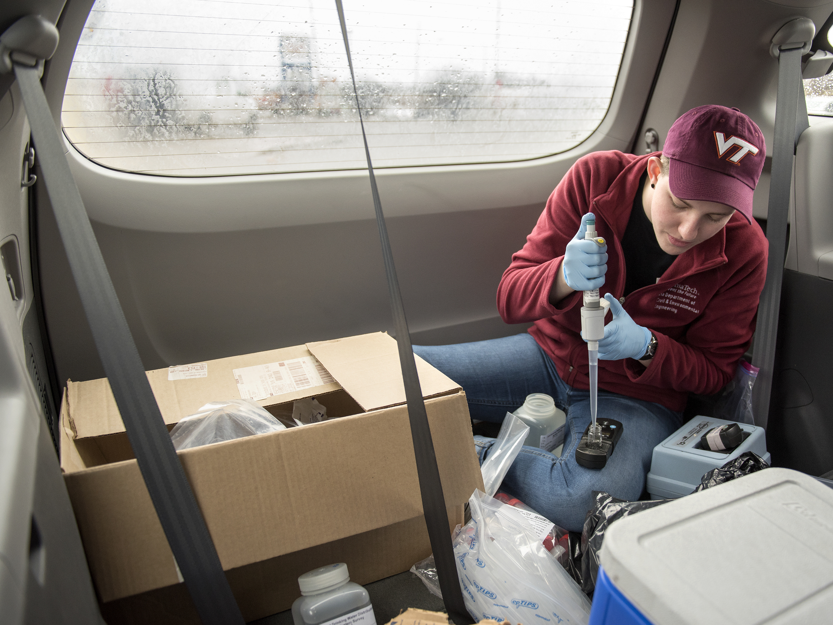 Maggie Carolan, part of Virginia Tech professor Marc Edwards' team, collects water samples and processes them in the back of their van in Flint.