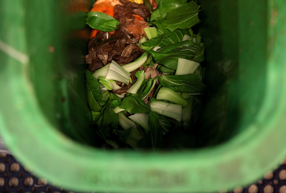 Food scraps are seen in a compost bin at a San Francisco restaurant. A new report ranks centralized composting as a top strategy for keeping food waste out of landfills, where it emits methane, a powerful greenhouse gas. (Justin Sullivan/Getty Images)