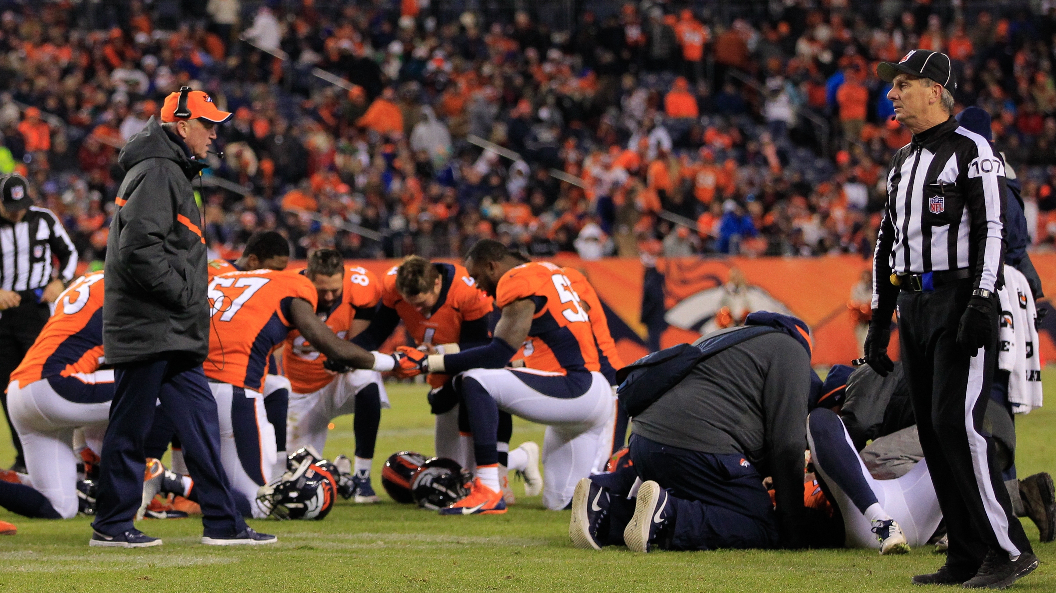 Before Monday, no NFL official had publicly acknowledged a link between football and chronic traumatic encephalopathy. Here, members of the Denver Broncos are seen after one of their teammates suffered a concussion during a game in late 2014. (Getty Images)