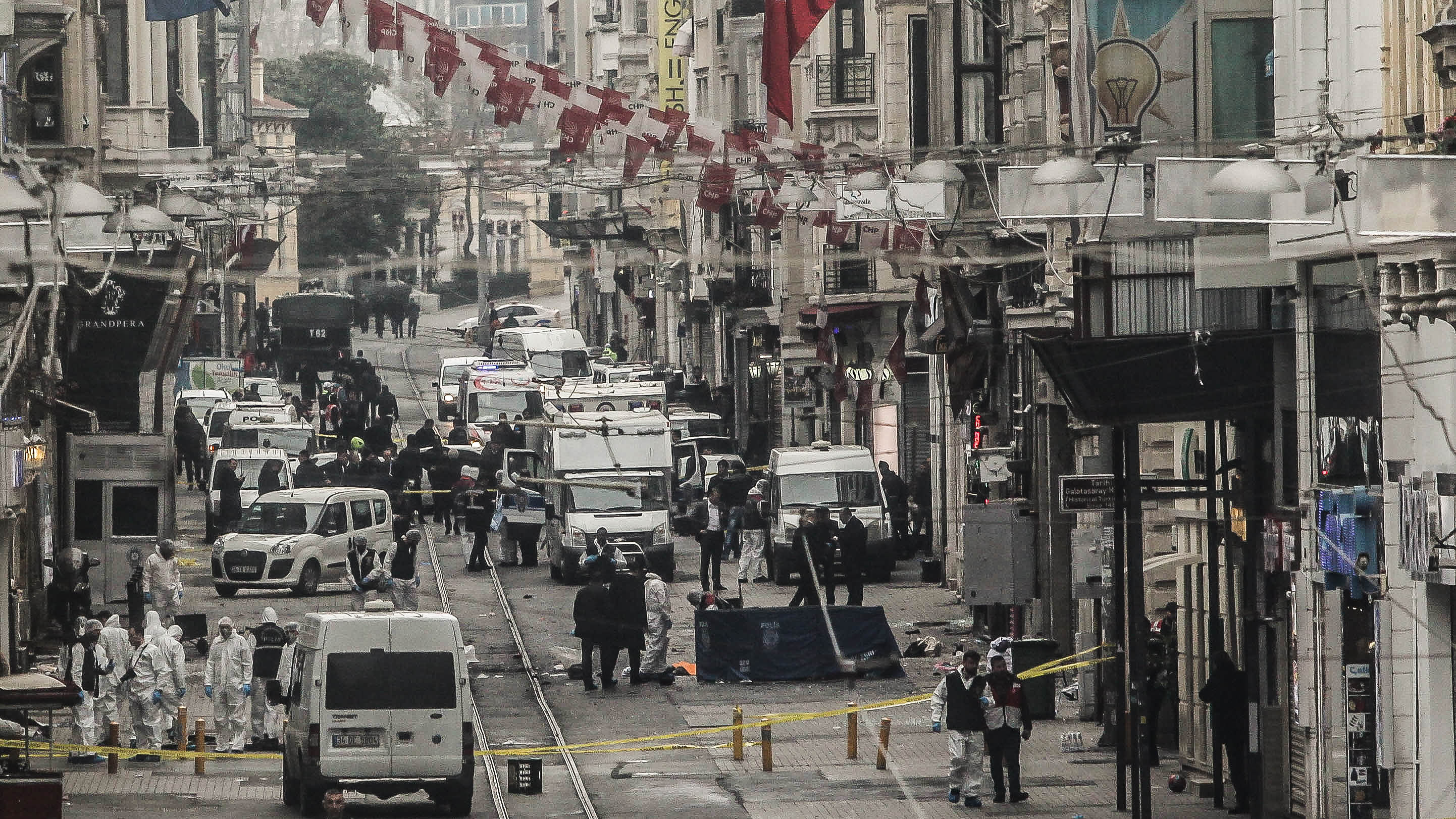 Emergency services inspect the area following a suicide bombing in a major shopping and tourist district in the central part of Istanbul on Saturday.