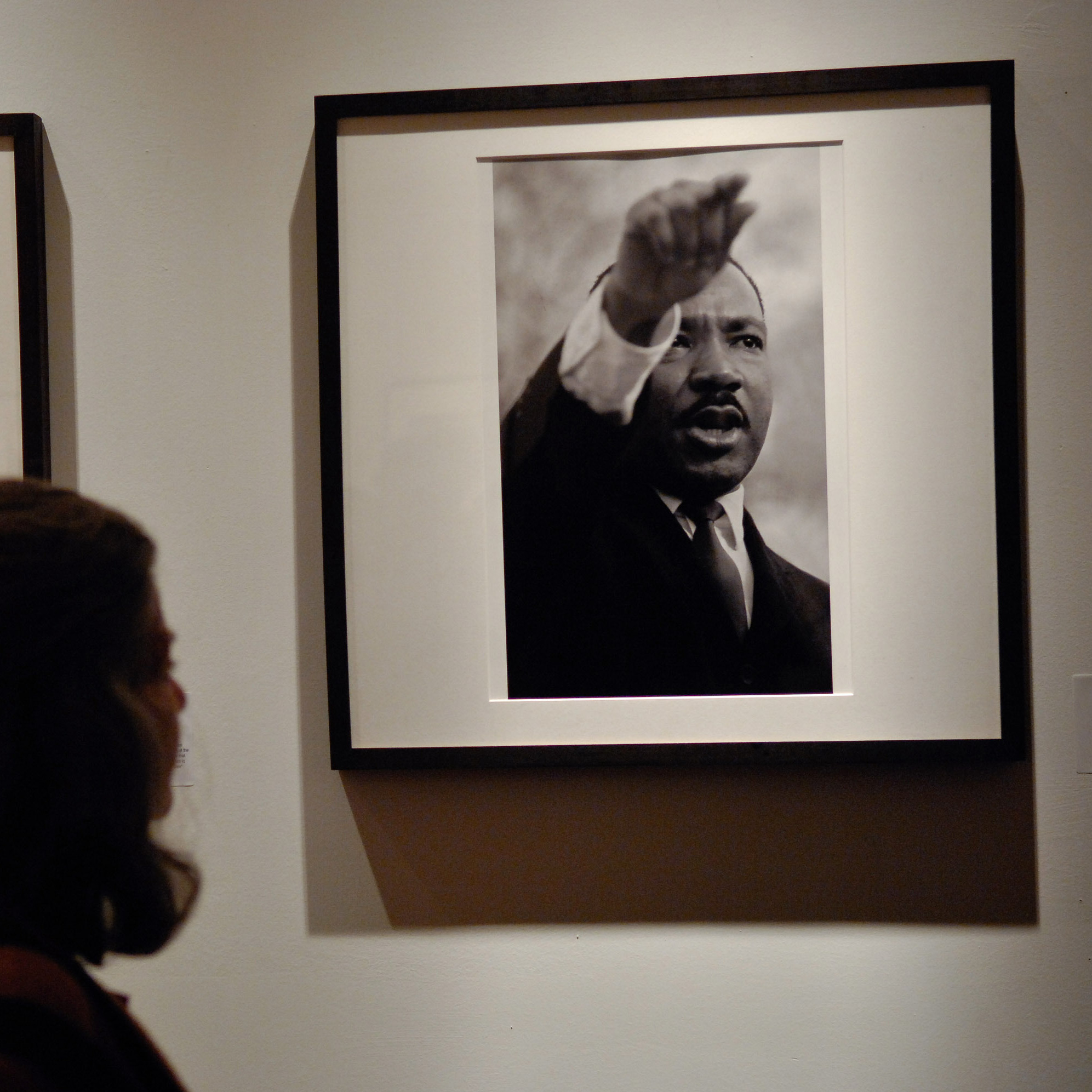Attendees view Bob Adelman's photography exhibit at the Westwood Gallery in New York City.
