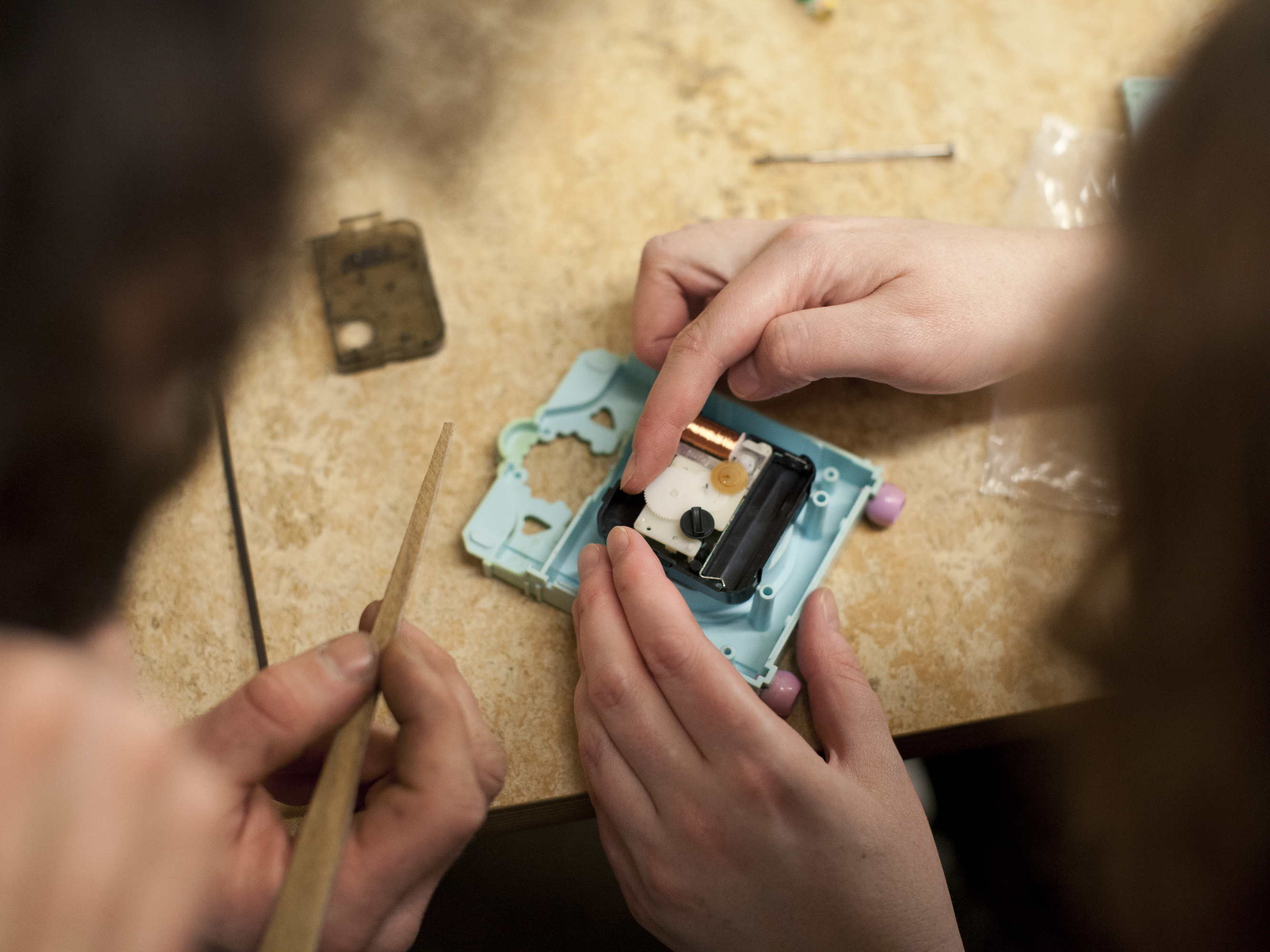 Esti Brennan (right) takes apart her Polly Pocket clock with the help of Matt McEntee.