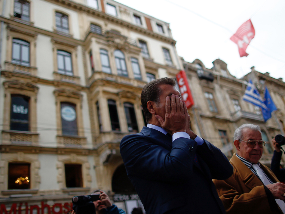 A man stands in front of a site in Istanbul where a suicide bomb blast last weekend ripped through a crowded pedestrian thoroughfare. (Emrah Gurel/AP)