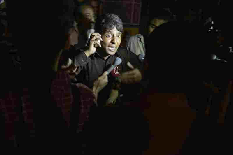 An eyewitness talks with media representatives after the explosion at the park, where families were gathered to enjoy springtime weather.