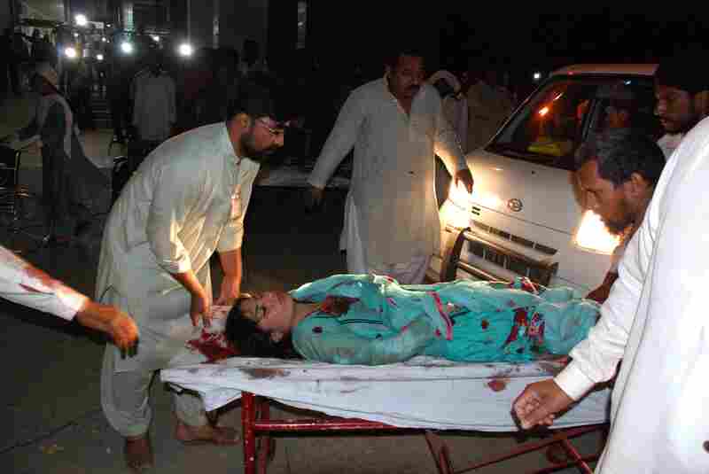 Relatives bring an injured woman to a hospital in Lahore.