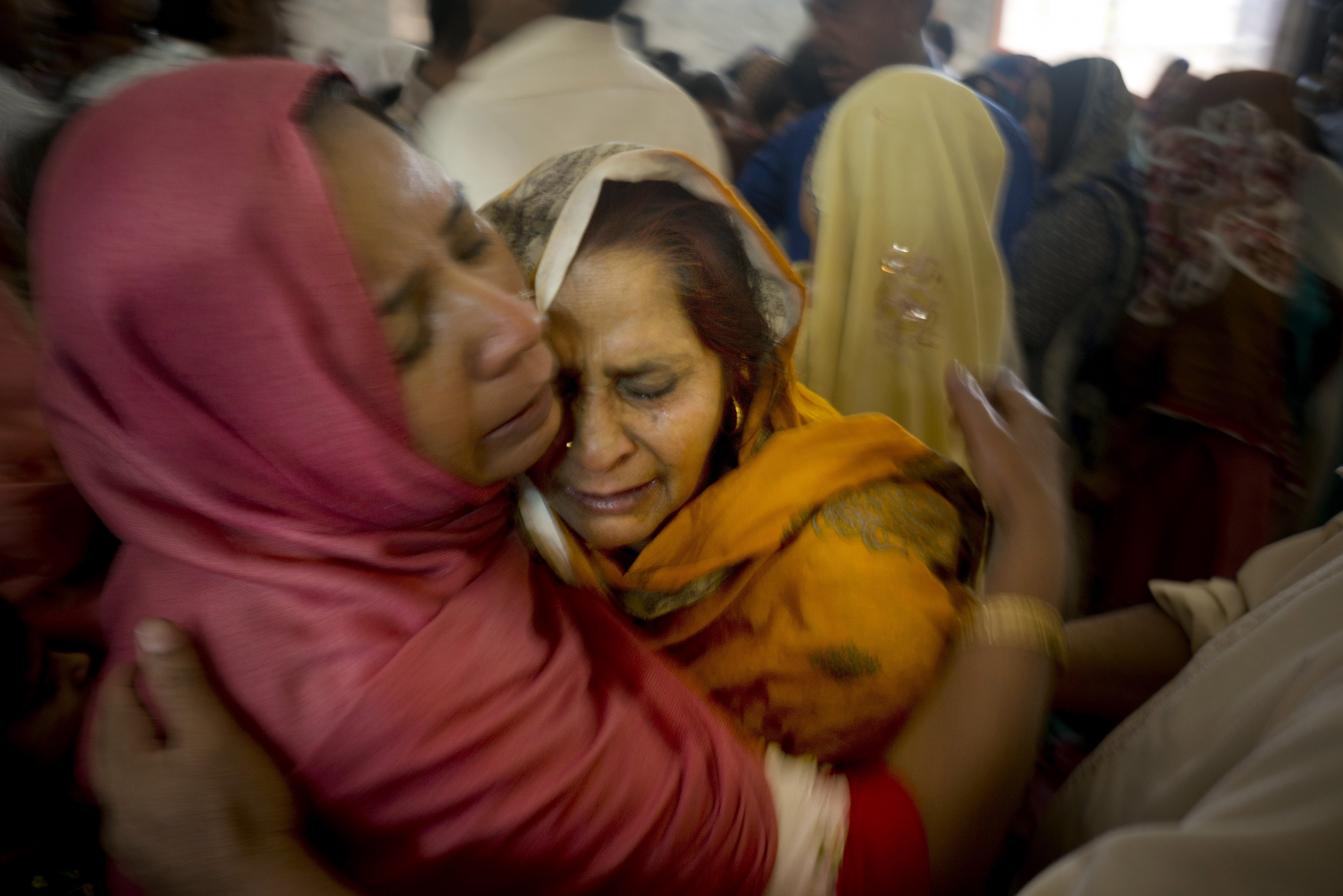 Pakistani Christian women mourn the deaths of their family members during a funeral service at a local church in Lahore, Pakistan, on Monday.