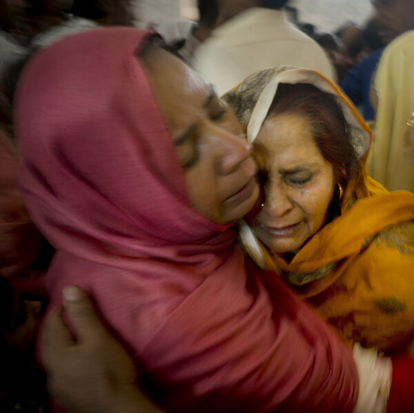 Pakistani Christian women mourn the deaths of their family members during a funeral service at a local church in Lahore, Pakistan, on Monday.