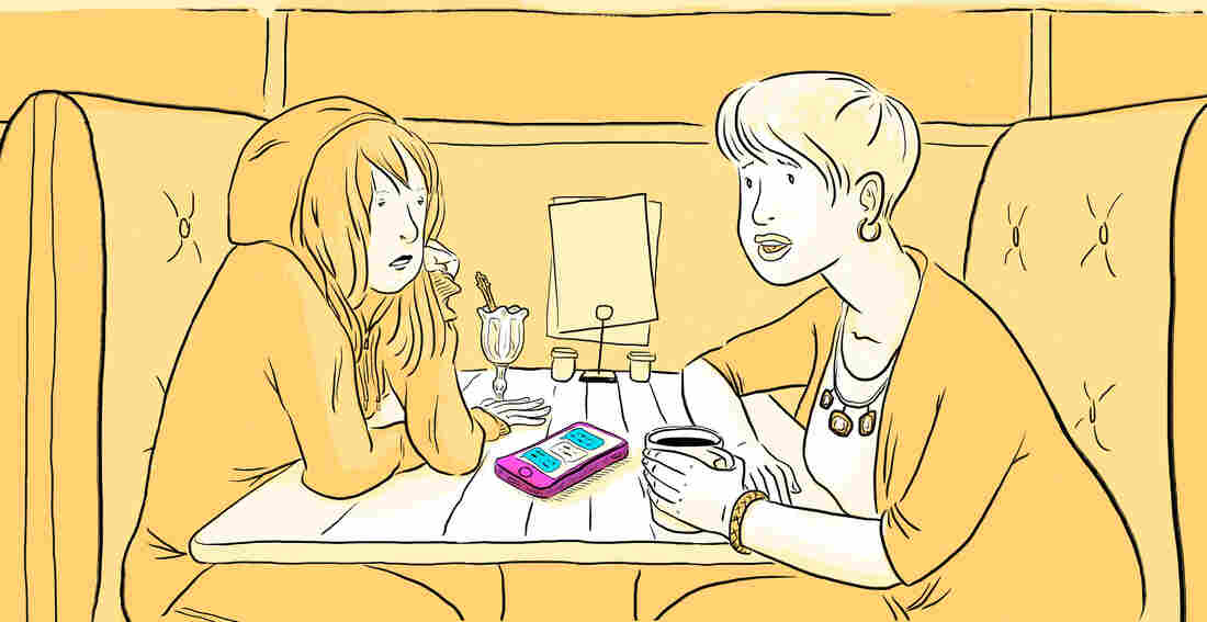 Mother and daughter discuss cell phone usage in a diner