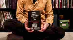 Bob Boilen holding a copy of his first book, Your Song Changed My Life.