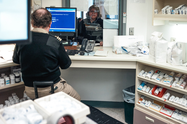 Hoff picks up prescriptions at the Indian Health Service clinic in Wagner. The pharmacy staff member is part of the U.S. Public Health Service Commissioned Corps.