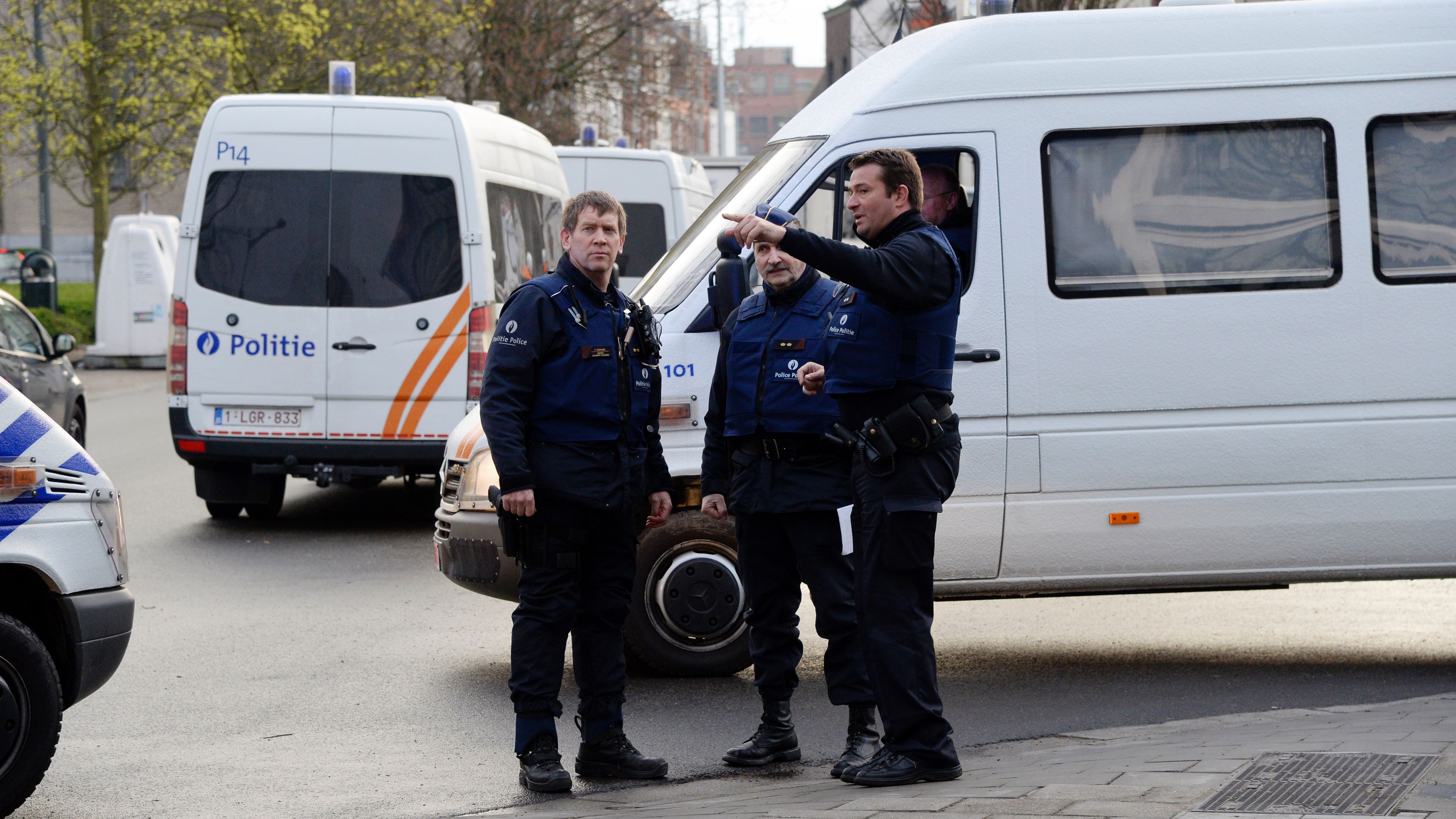 Belgian police officers stand in Albert I square in Brussels, where authorities arrested Mohamed Abrini, a key Paris attacks suspect, on Friday.