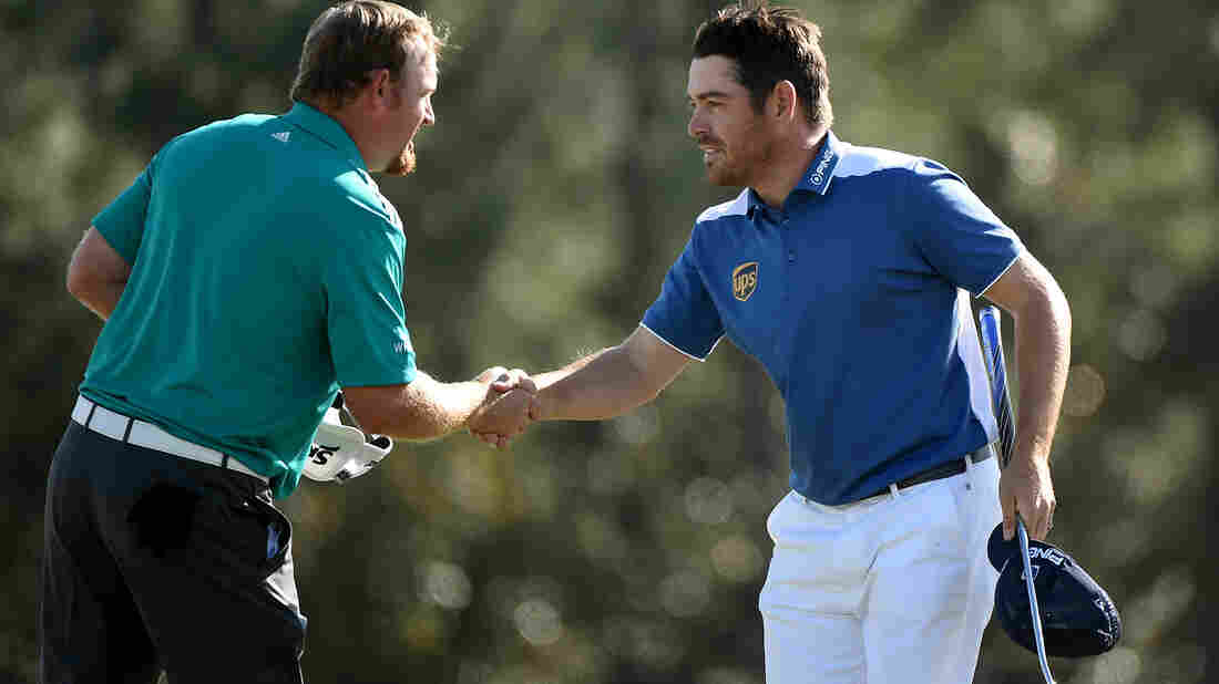 Louis Oosthuizen (right) shakes hands with his playing partner J.B. Holmes after the final round of the Masters on Sunday. Oosthuizen made an unlikely hole-in-one after his ball smacked Holmes' and then trickled into the cup. Louis Oosthuizen (right) shakes hands with his playing partner J.B. Holmes after the final round of the Masters on Sunday. Oosthuizen made an unlikely hole-in-one after his ball smacked Holmes' and then trickled into the cup.