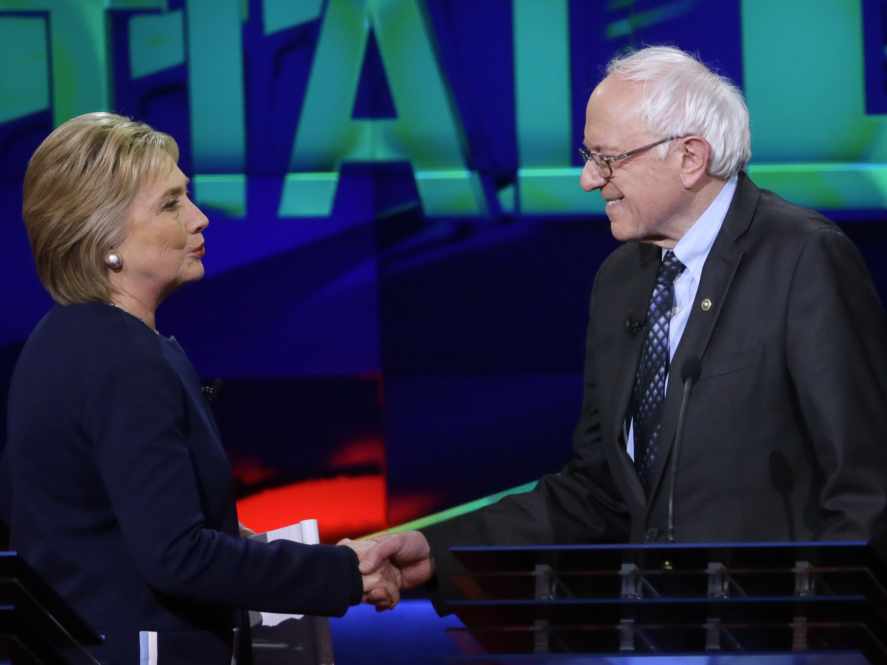 Hillary Clinton and Bernie Sanders shake hands at the end of a Democratic presidential primary debate last month.