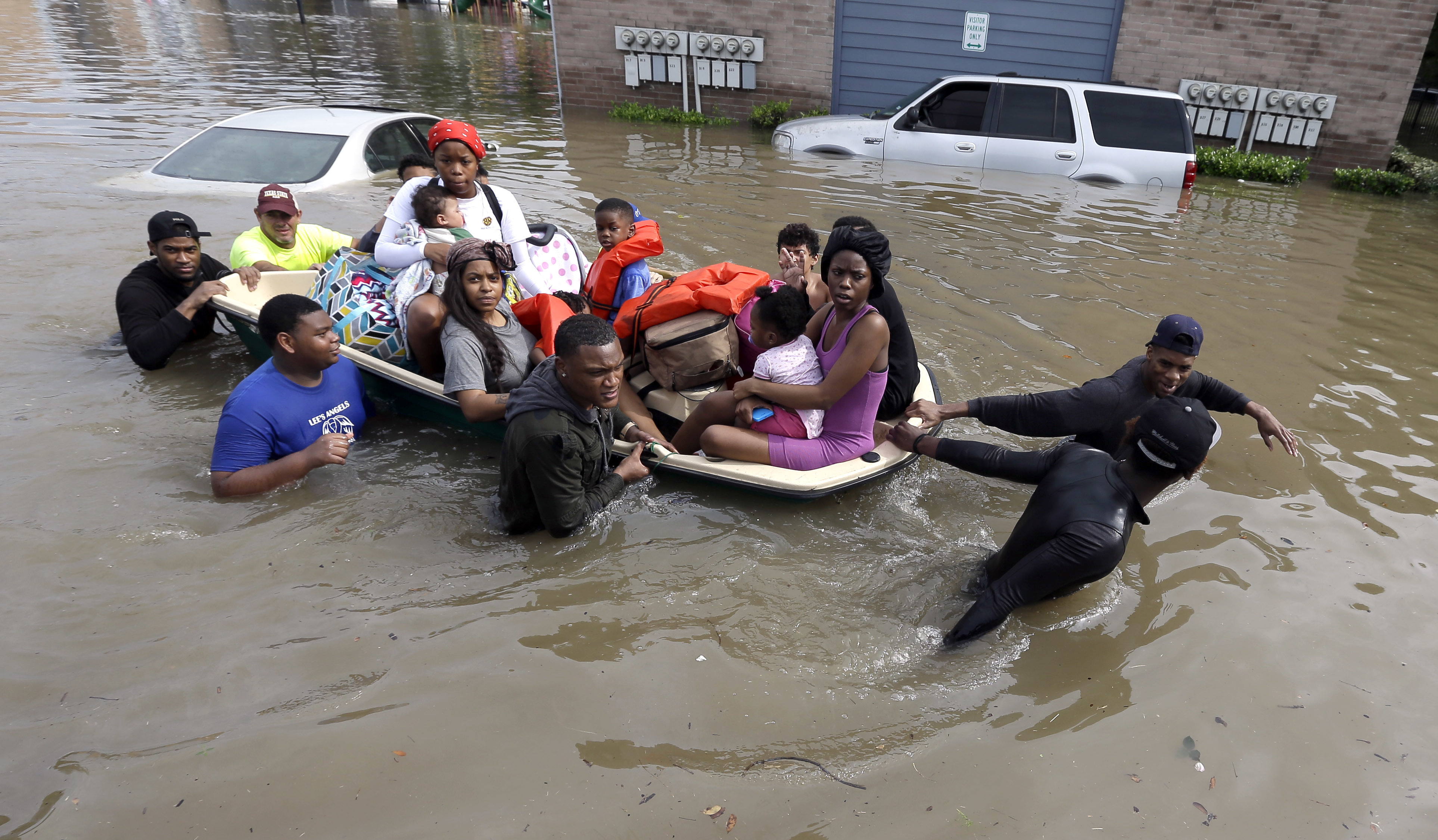 Residents evacuate their apartment complex Monday in Houston.