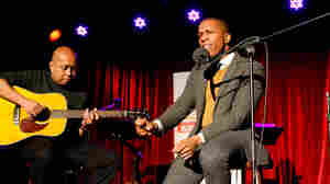 Guitarist Robin Macatangay (L) and Leslie Odom Jr. perform on Ask Me Another, live at the Bell House.Â (R).