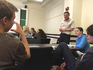 Dr. Carl Wieman listens in on a small group discussion during his introductory quantum mechanics course at Stanford University.