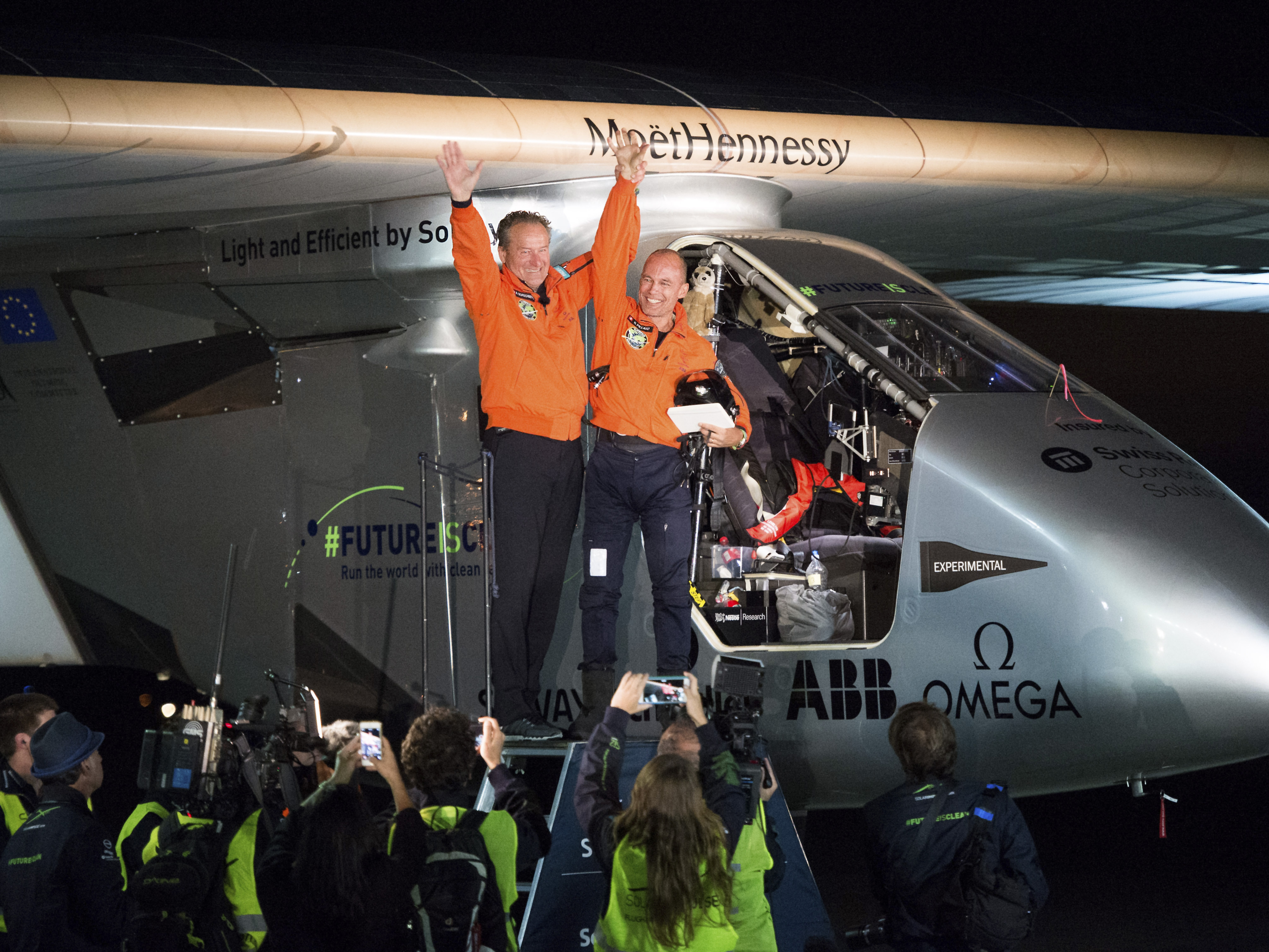 Solar Impulse 2 pilots Bertrand Piccard (right) and Andre Borschberg celebrate after Piccard landed their solar-powered plane at Moffett Field in Mountain View, Calif., on Saturday.