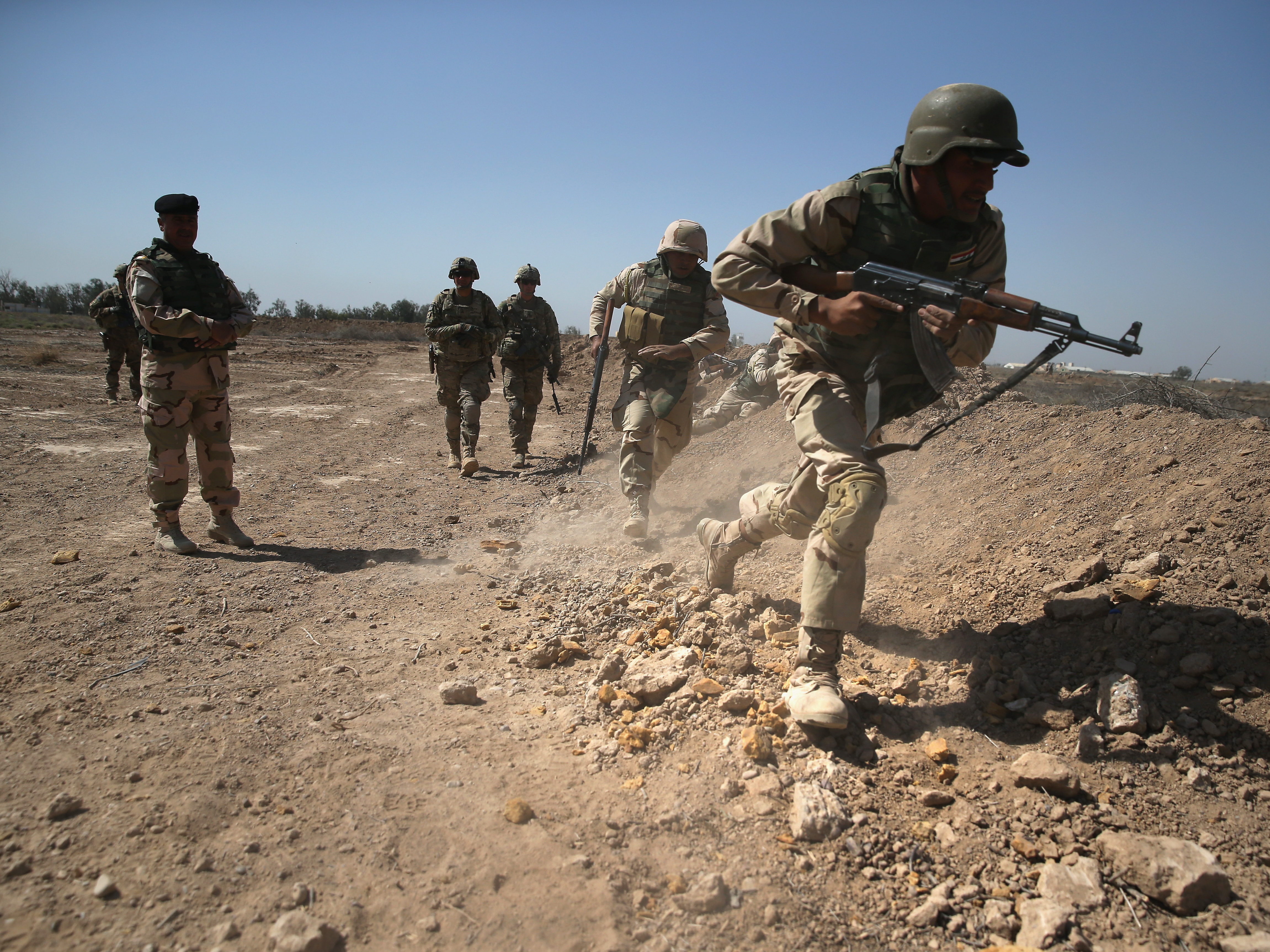 Army trainers conduct drills at a military base in Taji, Iraq last year.