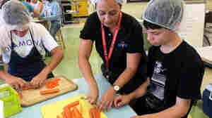 Willard Middle School students chop carrots for a meal they will sell through Josephine.