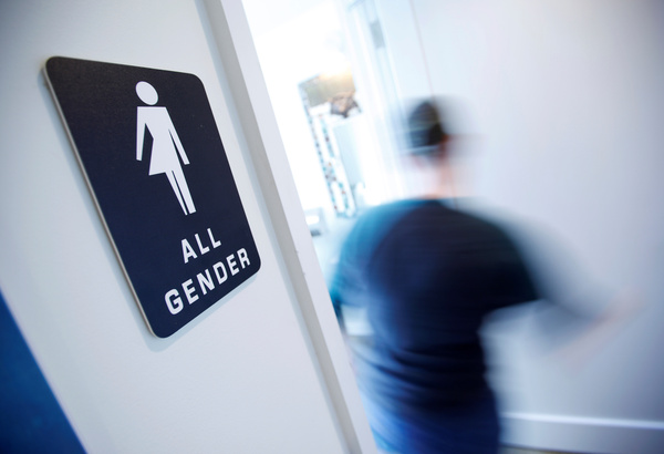 A bathroom sign welcomes both genders at the Cacao Cinnamon coffee shop in Durham, N.C., on May 3.