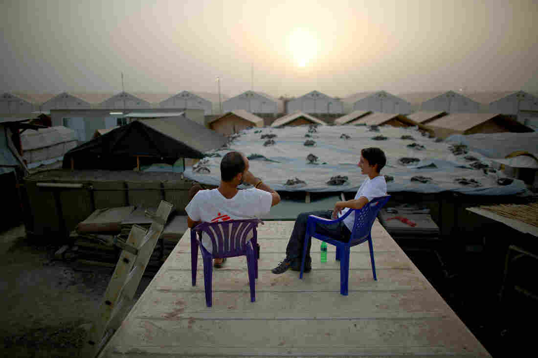 Dr. Nav and Anissa Dickerson take a break on the roof of a shipping container at sundown. Dr. Nav and Anissa Dickerson take a break on the roof of a shipping container at sundown.