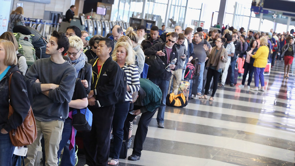 Passengers wait in line to be screened at a Transportation Security Administration checkpoint at Chicago's O'Hare International Airport on Monday.