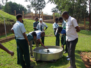 Rwandan officials inspect equipment at a weather observation station.