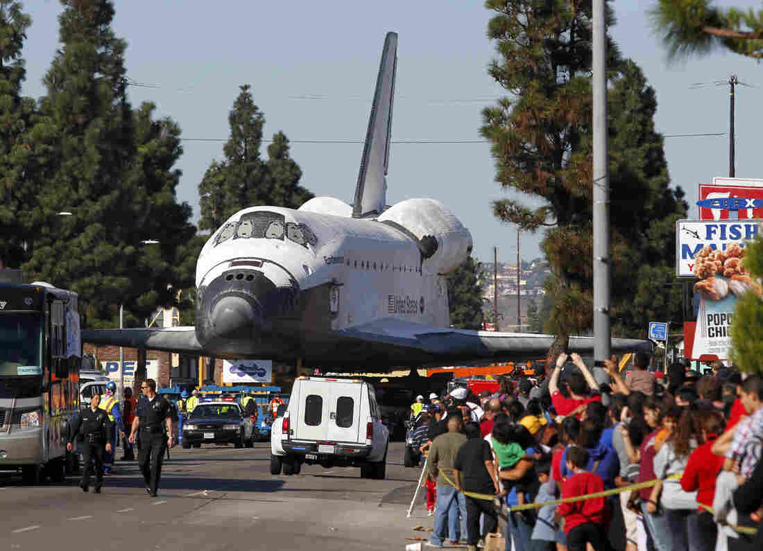 Fans watch the Space Shuttle Endeavour slowly move down Martin Luther King Blvd. in Los Angeles in 2012.