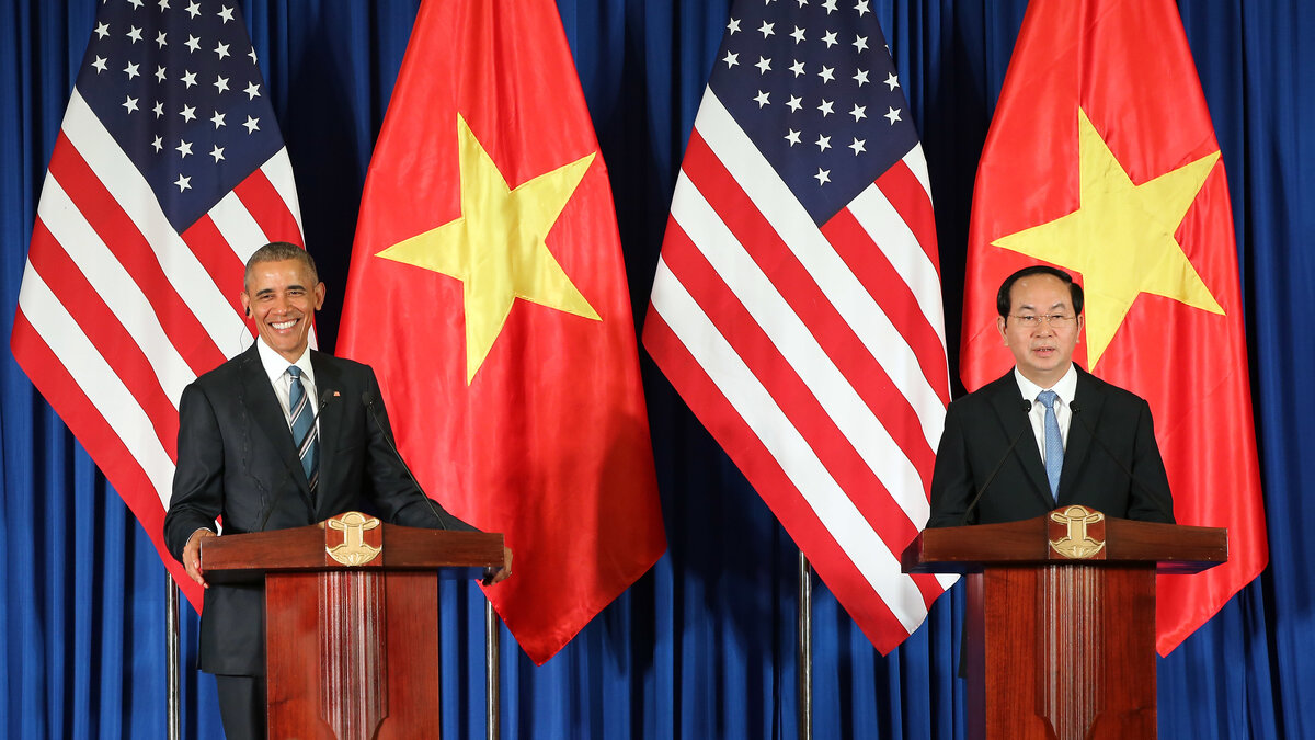 Vietnamese President Tran Dai Quang and U.S. President Obama take part in a joint press conference Monday at the International Convention Center in Hanoi.