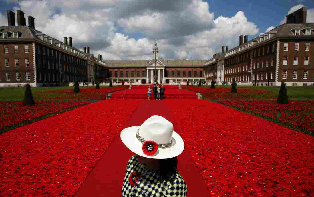 A volunteer stands to the entrance of the 5000 Poppies Garden at the Chelsea Flower Show, created by Australians Lynn Berry and Margaret Knight with designer Phillip Johnson. The project began as a small tribute to Berry and Knight's fathers, who fought in World War II. A volunteer stands to the entrance of the 5000 Poppies Garden at the Chelsea Flower Show, created by Australians Lynn Berry and Margaret Knight with designer Phillip Johnson. The project began as a small tribute to Berry and Knight's fathers, who fought in World War II.