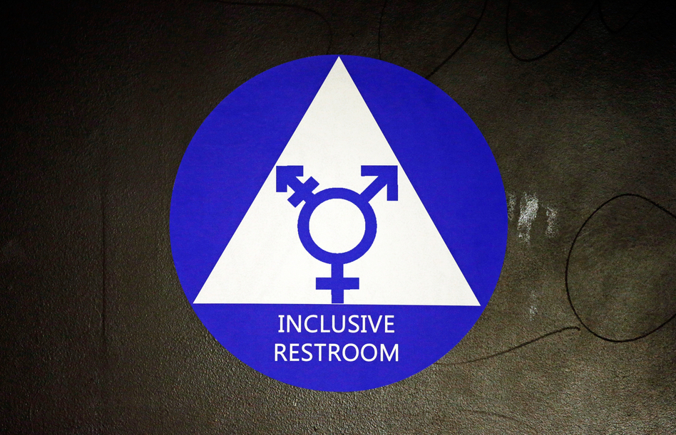A new sticker designates a gender neutral bathroom at a high school in Seattle. President Obama's directive ordering schools to accommodate transgender students has been controversial in some places, leading 11 states to file a lawsuit against the Obama administration in response. (Elaine Thompson/AP)