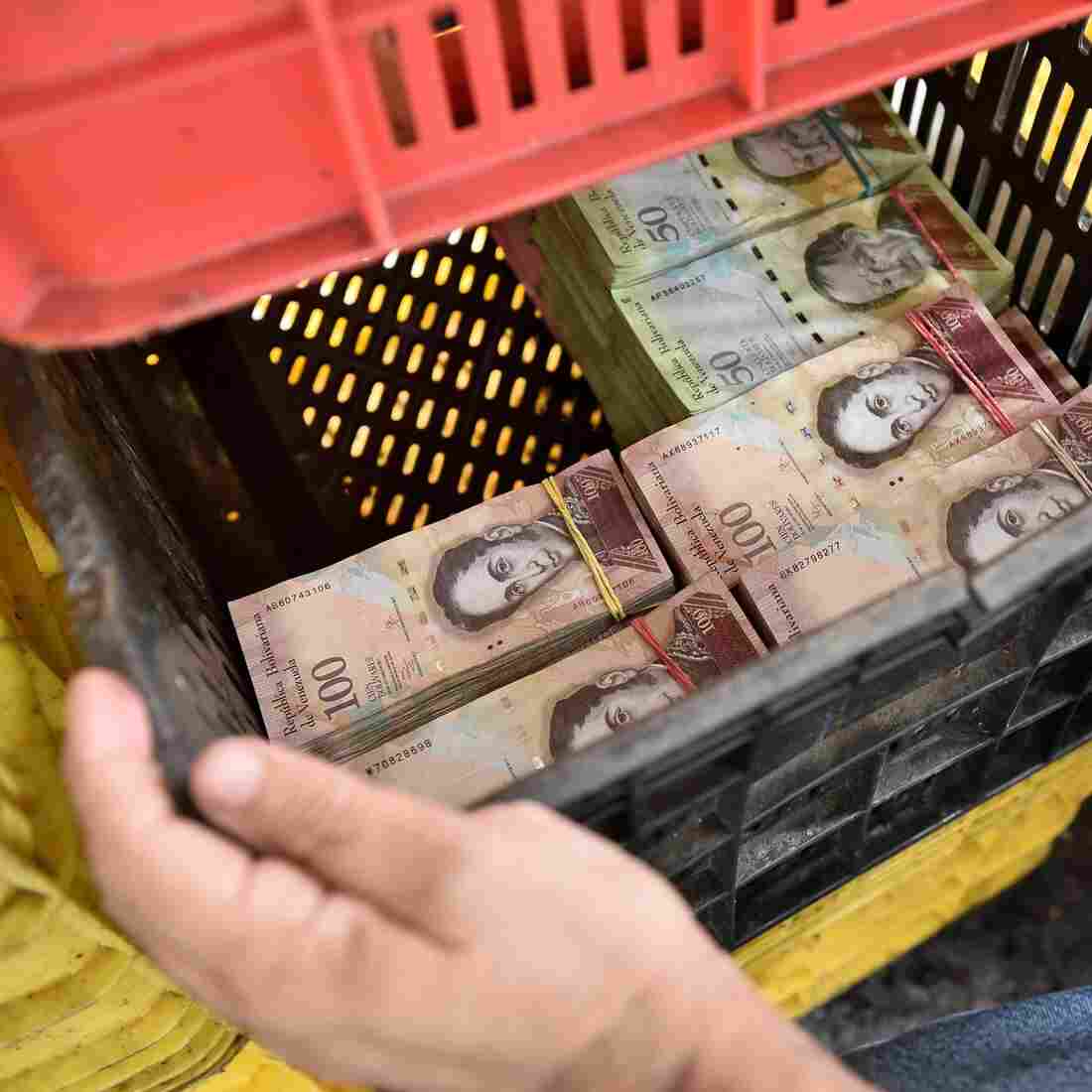 A man uses a vegetable container to carry currency notes in a market in Caracas on May 21. Amid a crushing economic crisis and triple-digit inflation, Venezuela's bolivar has lost so much value that the largest bill, the 100-bolivar note, is now worth less than a dime on the black market. A man uses a vegetable container to carry currency notes in a market in Caracas on May 21. Amid a crushing economic crisis and triple-digit inflation, Venezuela's bolivar has lost so much value that the largest bill, the 100-bolivar note, is now worth less than a dime on the black market.