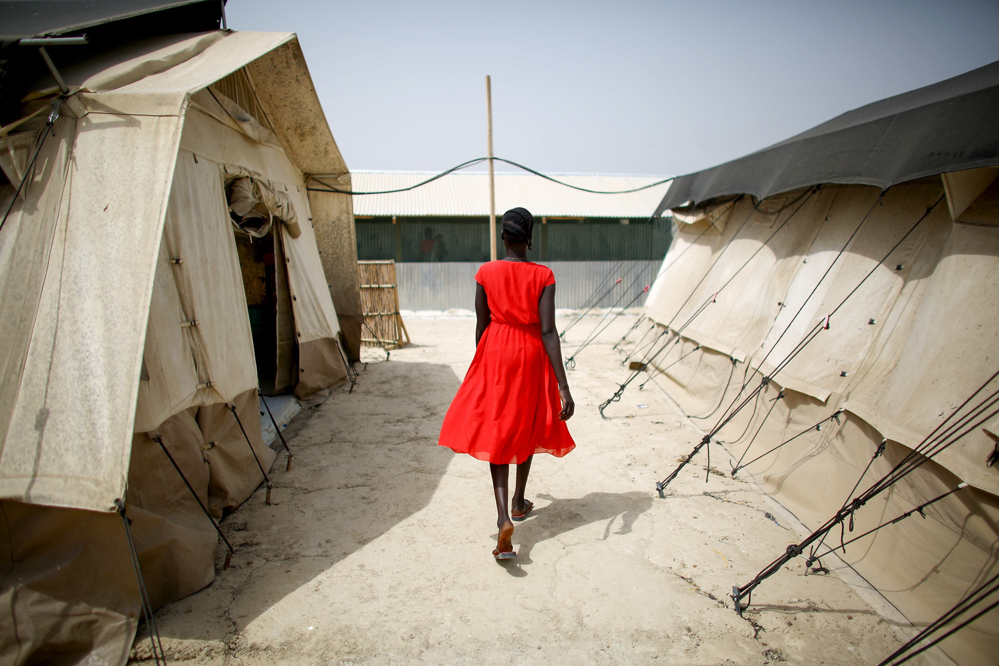 Earlier this year, a woman walks between two of the tents that house the hospital wards at the U.N. Protection of Civilians site near Bentiu, South Sudan, home to more than 120,000 people. Most of the camp's residents are women and children.