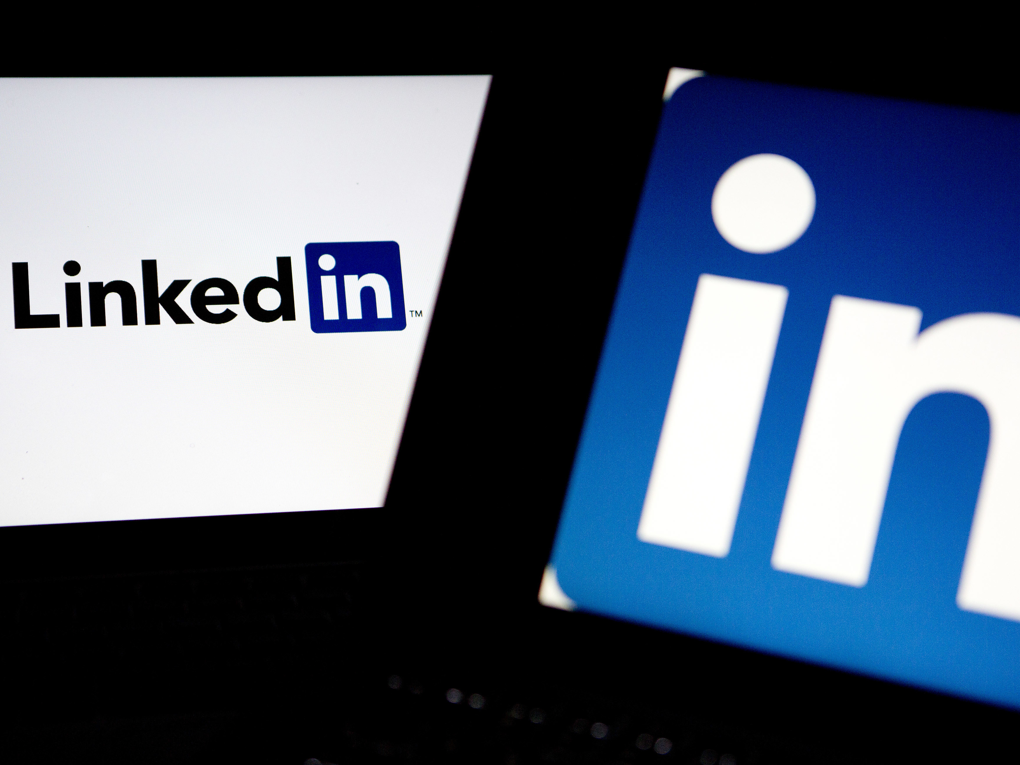 LinkedIn logos are displayed on laptop computers for an illustration.