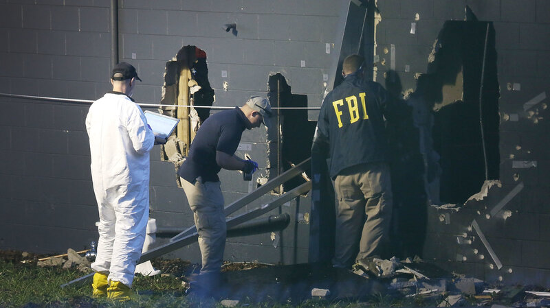 FBI agents inspect the rear wall of the Pulse Orlando nightclub in Orlando, Fla., where authorities say 49 victims died Sunday. The gunman, identified as Omar Mateen, was killed by police. FBI agents inspect the rear wall of the Pulse Orlando nightclub in Orlando, Fla., where authorities say 49 victims died Sunday. The gunman, identified as Omar Mateen, was killed by police.