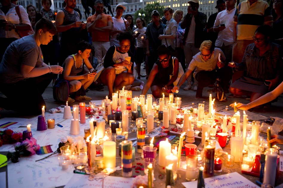 People gather Monday in Philadelphia for a vigil in memory of the victims of the Orlando, Fla., mass shooting. (Matt Rourke/AP)