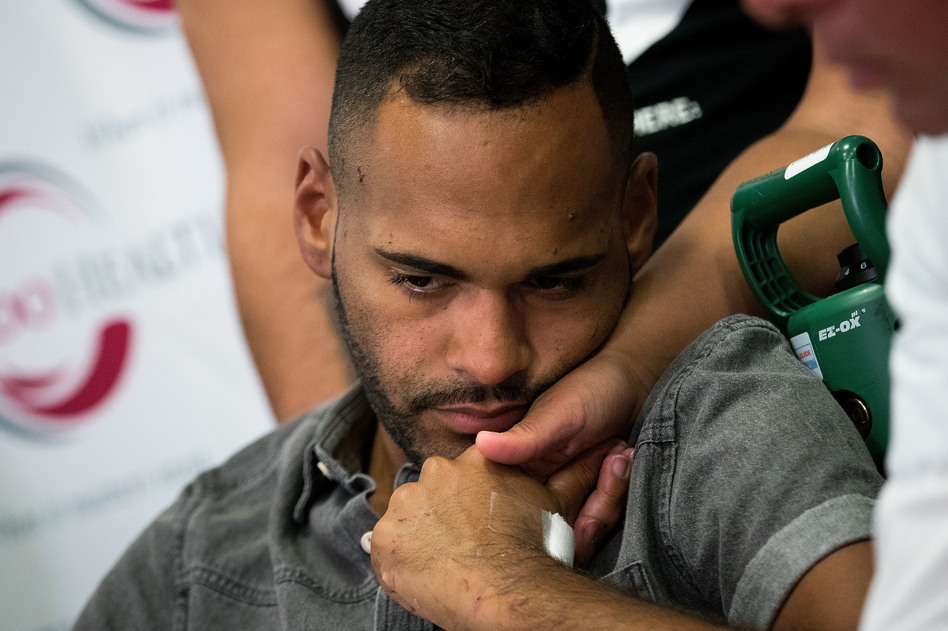 Angel Colon, who was injured in the Pulse nightclub shooting, is comforted by siblings during a press conference at the Orlando Regional Medical Center on Tuesday. (Drew Angerer/Getty Images)