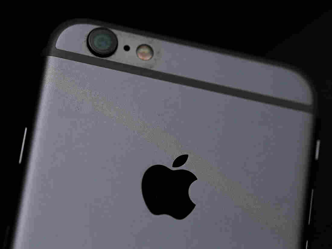 The Apple logo is displayed on an iPhone 6.